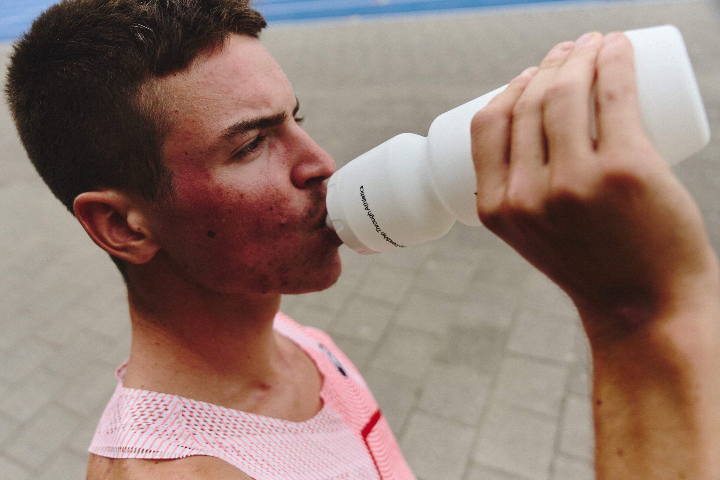 Runner drinking from a GONNA bottle after a hard effort